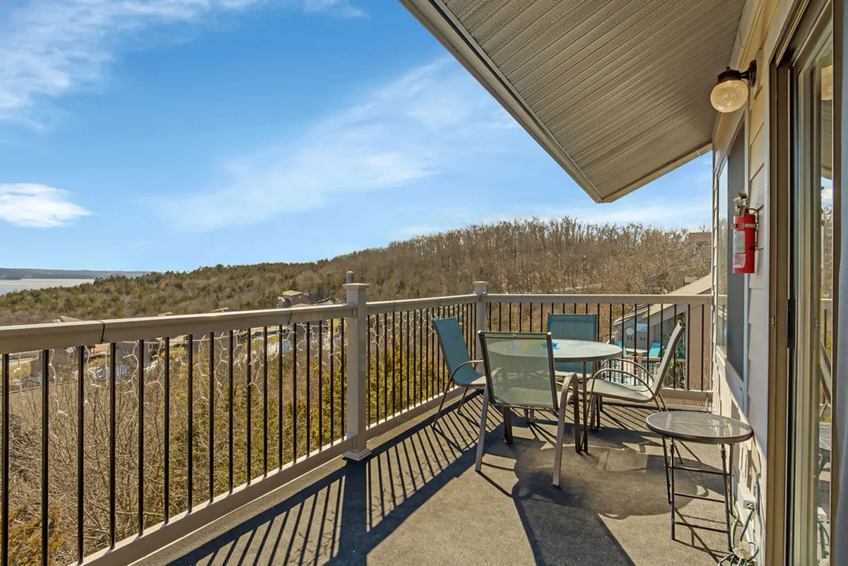 This exterior scene shows a patio table and chairs overlooking a scenic landscape, ideal for outdoor dining or relaxation. The wide view suggests proximity to nature and opportunities for guests to enjoy the environment, echoing the section’s theme of value and accessibility to area experiences.